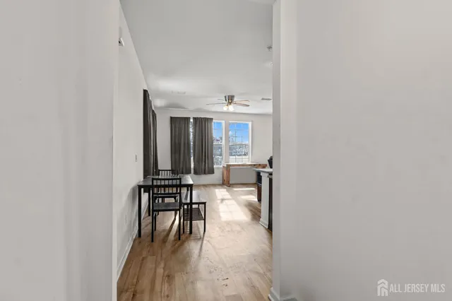 a view of a livingroom with furniture and hardwood floor
