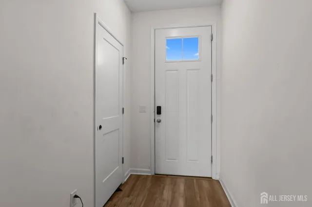 a view of a hallway with wooden floor