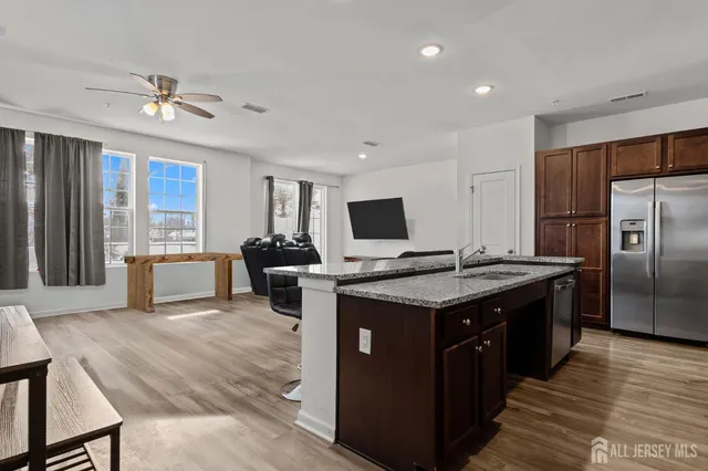 a kitchen with stainless steel appliances granite countertop a stove and a refrigerator