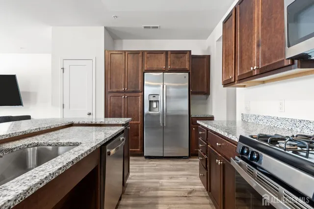 a kitchen with a refrigerator stove and sink