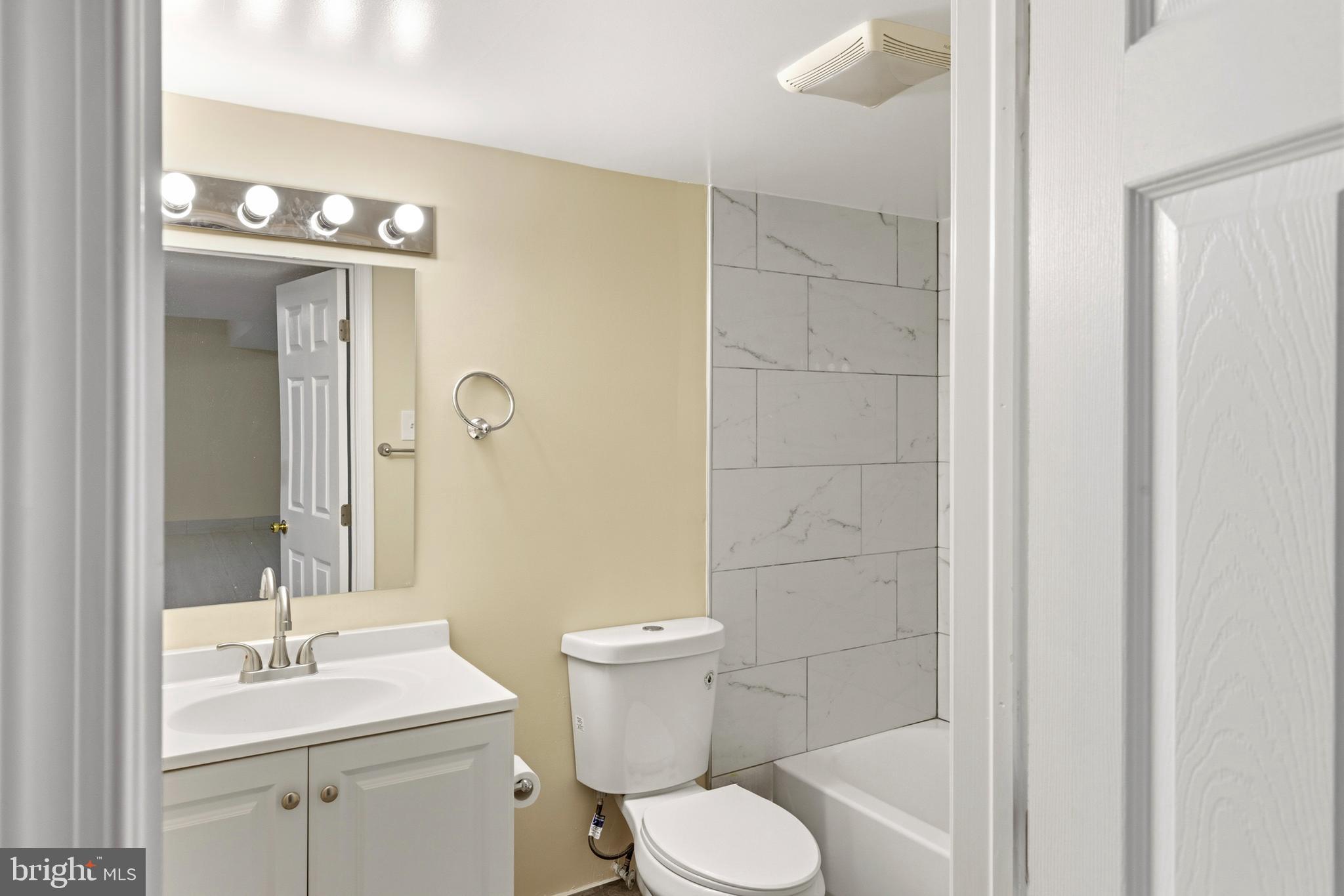4704 Denview Way Baltimore, MD 21206 - Photo 33 of 42 a bathroom with a sink a toilet a mirror and shower