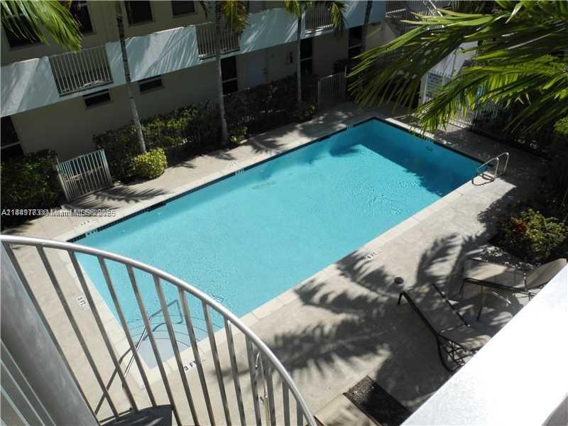 8950 Southwest 69th Court, Unit 312 Pinecrest, FL 33156 - Photo 2 of 13 a view of a balcony with chairs