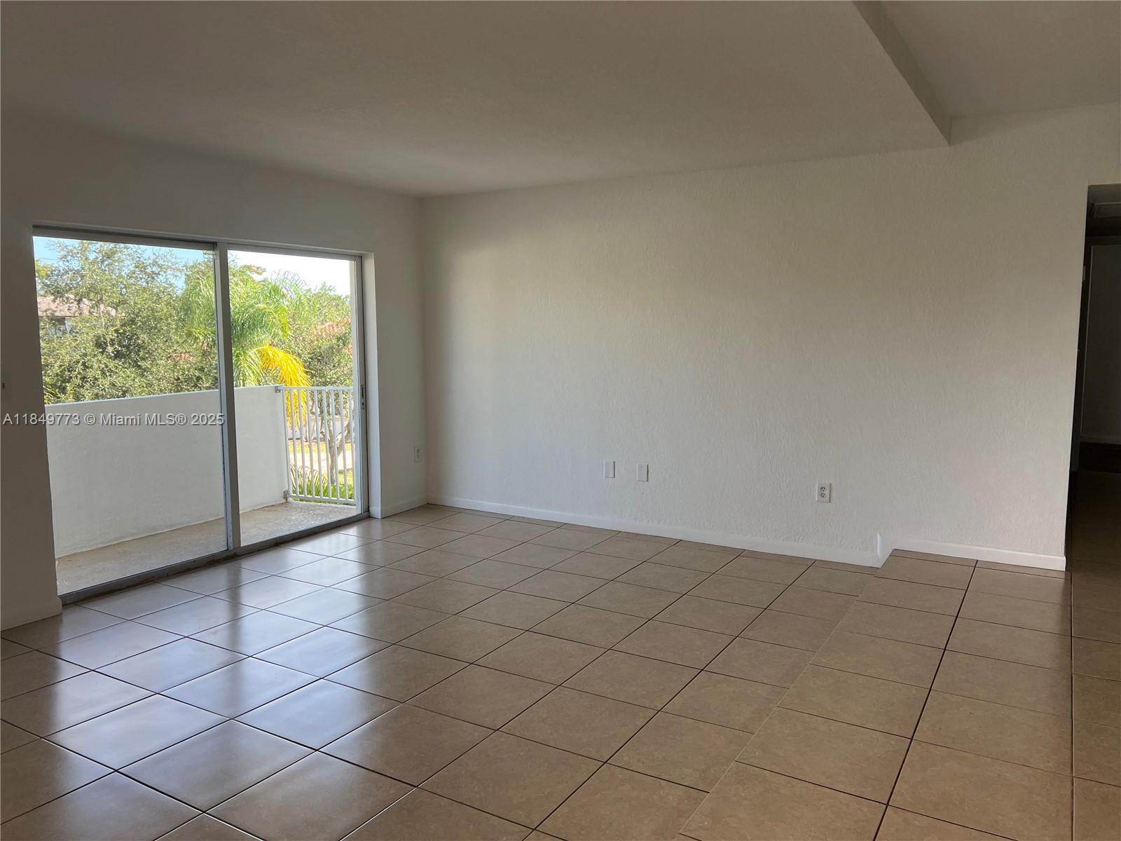 8950 Southwest 69th Court, Unit 312 Pinecrest, FL 33156 - Photo 4 of 13 an empty room with windows