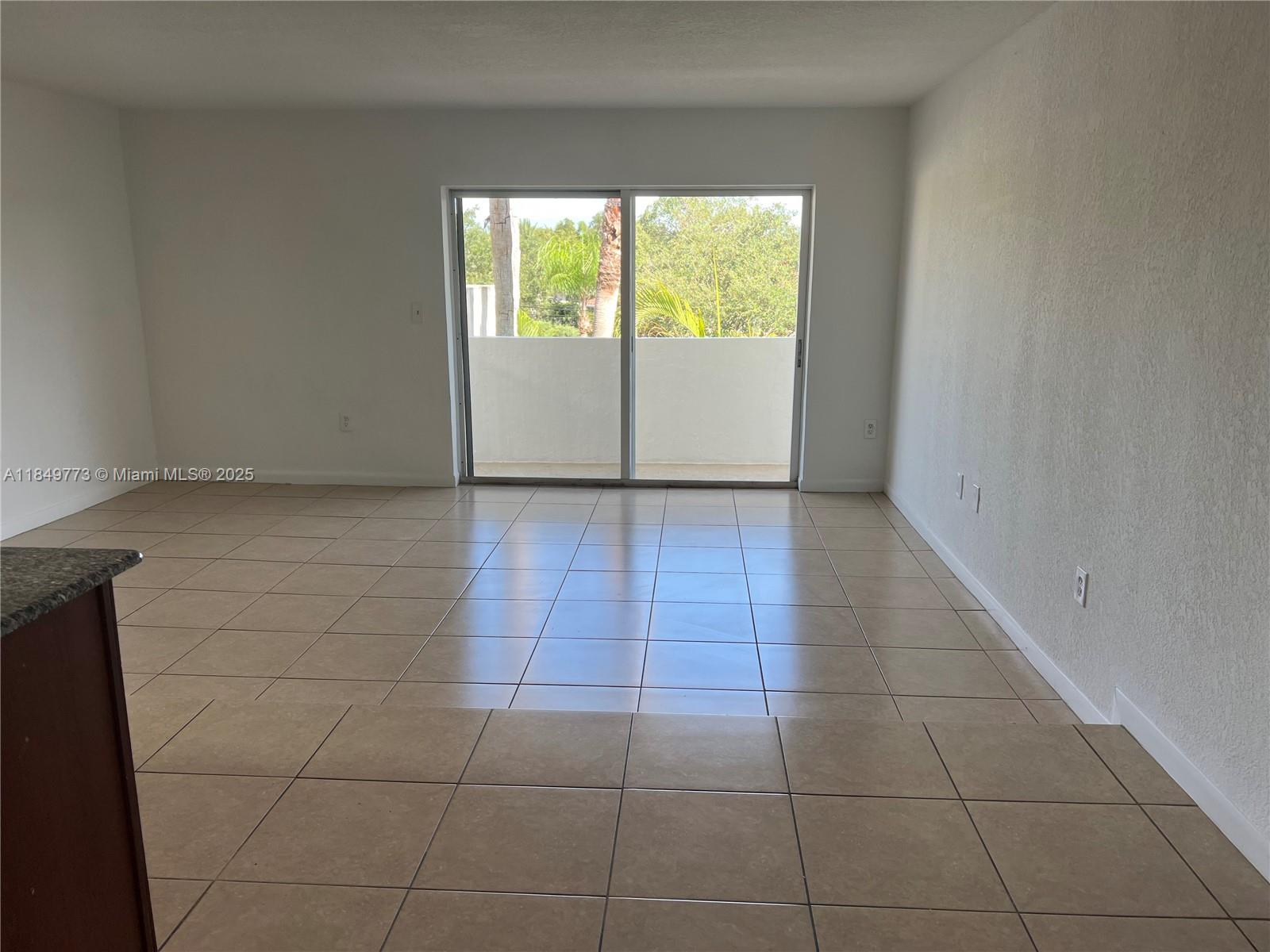 8950 Southwest 69th Court, Unit 312 Pinecrest, FL 33156 - Photo 5 of 13 a view of a livingroom with an empty space and window