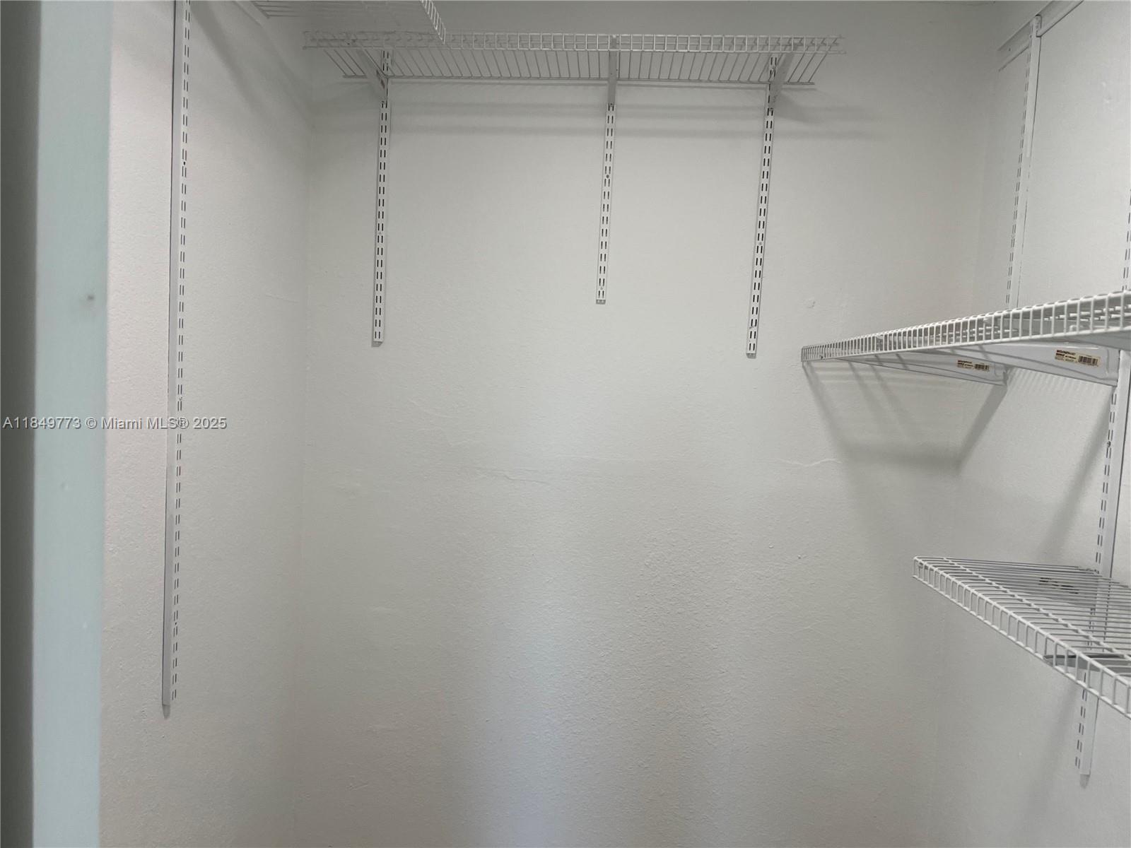 8950 Southwest 69th Court, Unit 312 Pinecrest, FL 33156 - Photo 10 of 13 a view of a room with racks on the wall