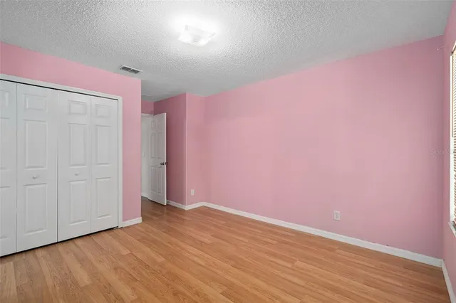 an empty room with wooden floor