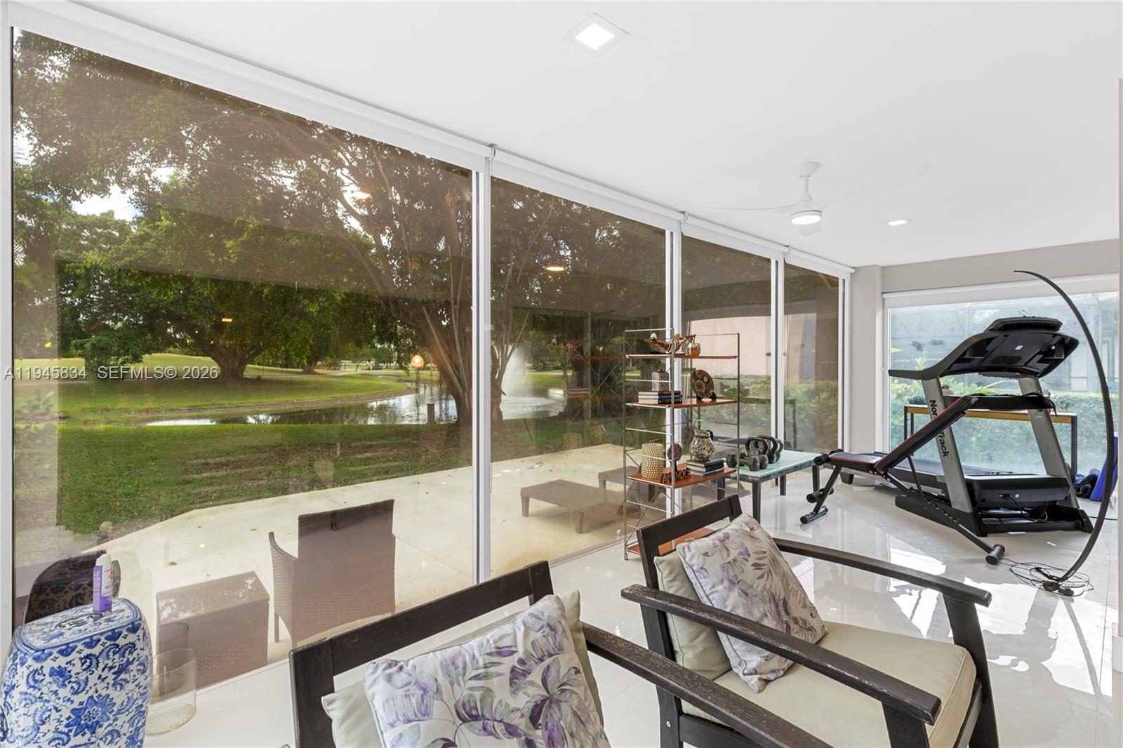19648 Back 9 Drive Boca Raton, FL 33498 - Photo 11 of 45 a room with view of living room with furniture and floor to ceiling window