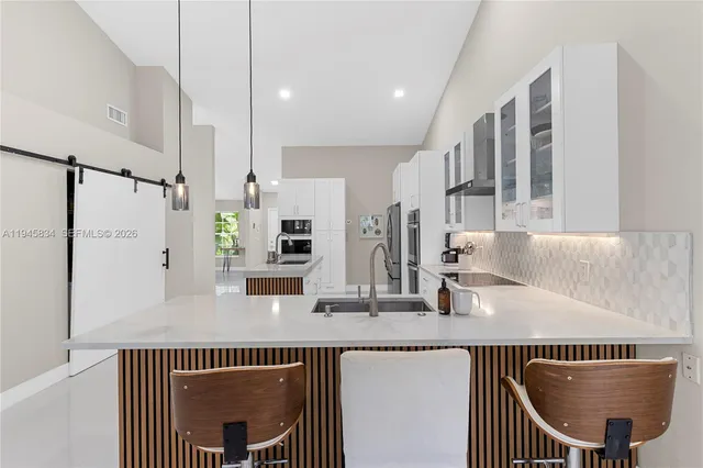 a kitchen with stainless steel appliances a sink and a refrigerator
