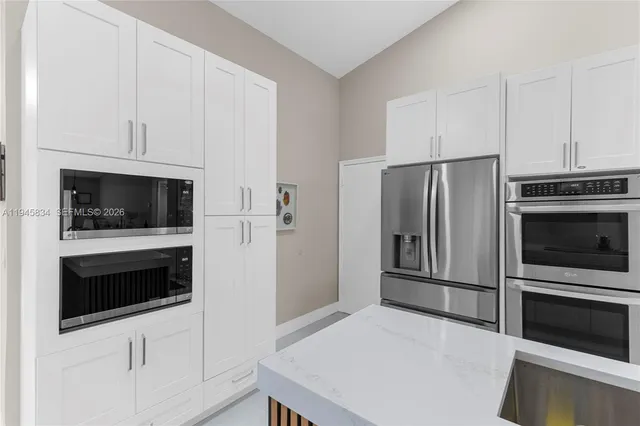 a kitchen with stainless steel appliances a stove a microwave and a refrigerator