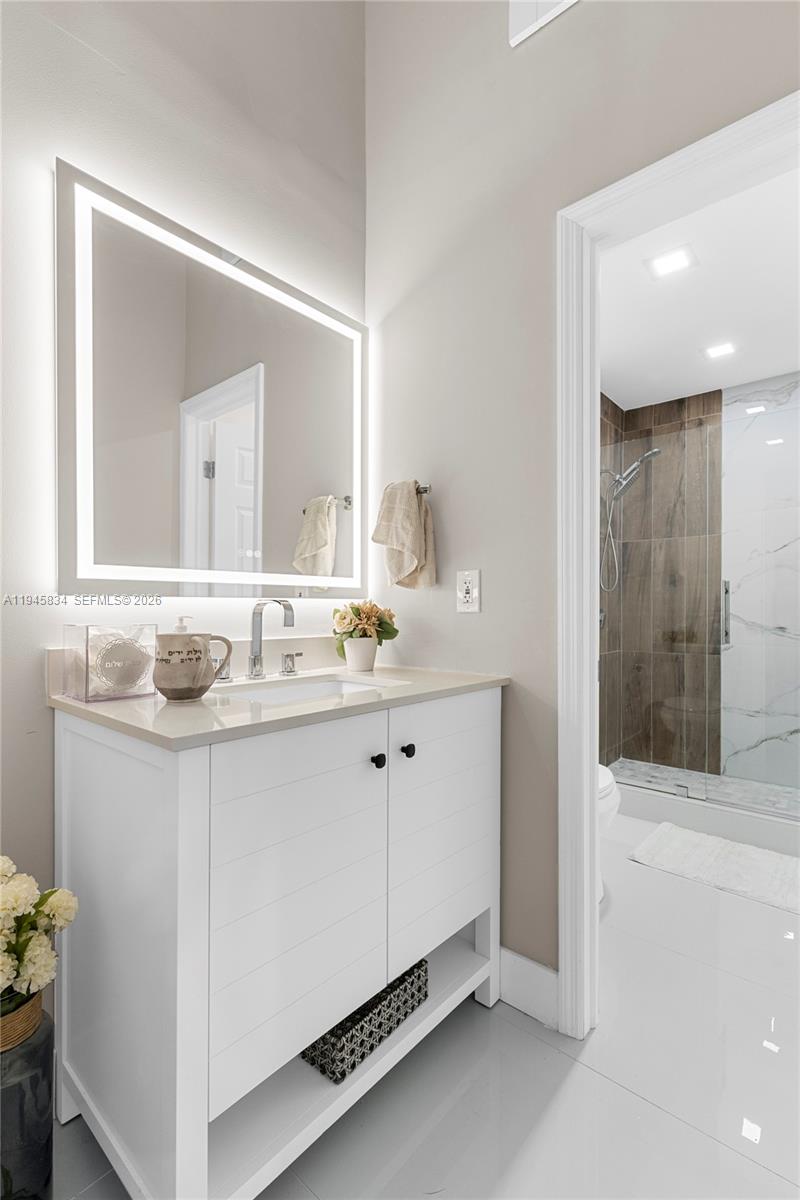 19648 Back 9 Drive Boca Raton, FL 33498 - Photo 18 of 45 a bathroom with double sink and a mirror