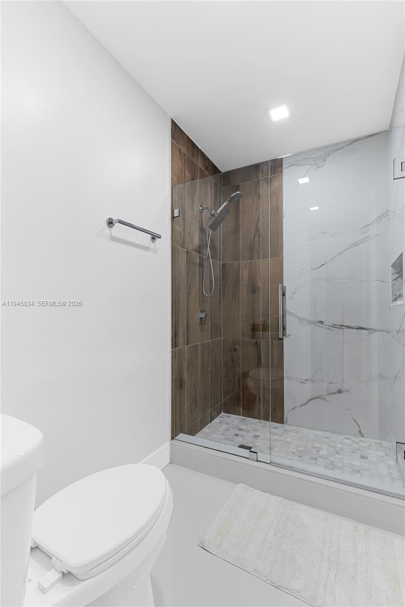 19648 Back 9 Drive Boca Raton, FL 33498 - Photo 19 of 45 a bathroom with a shower and a toilet