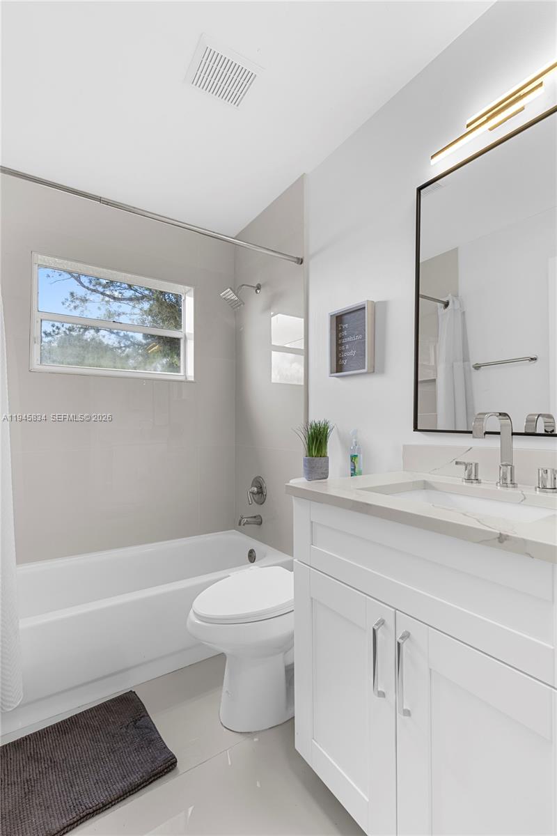 19648 Back 9 Drive Boca Raton, FL 33498 - Photo 20 of 45 a bathroom with a sink a toilet and bathtub