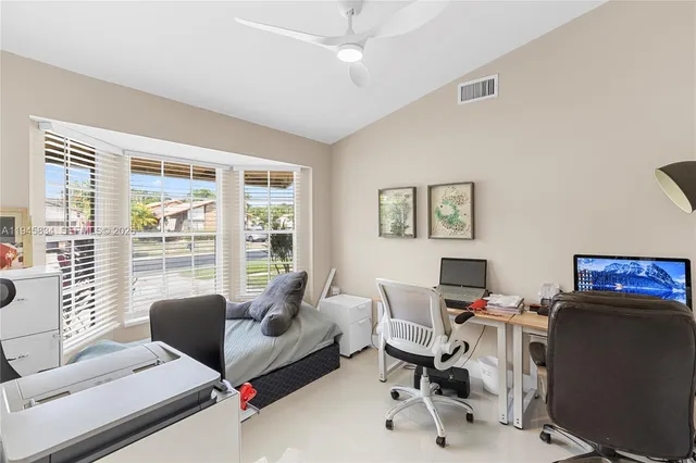a view of a livingroom with workspace and a window