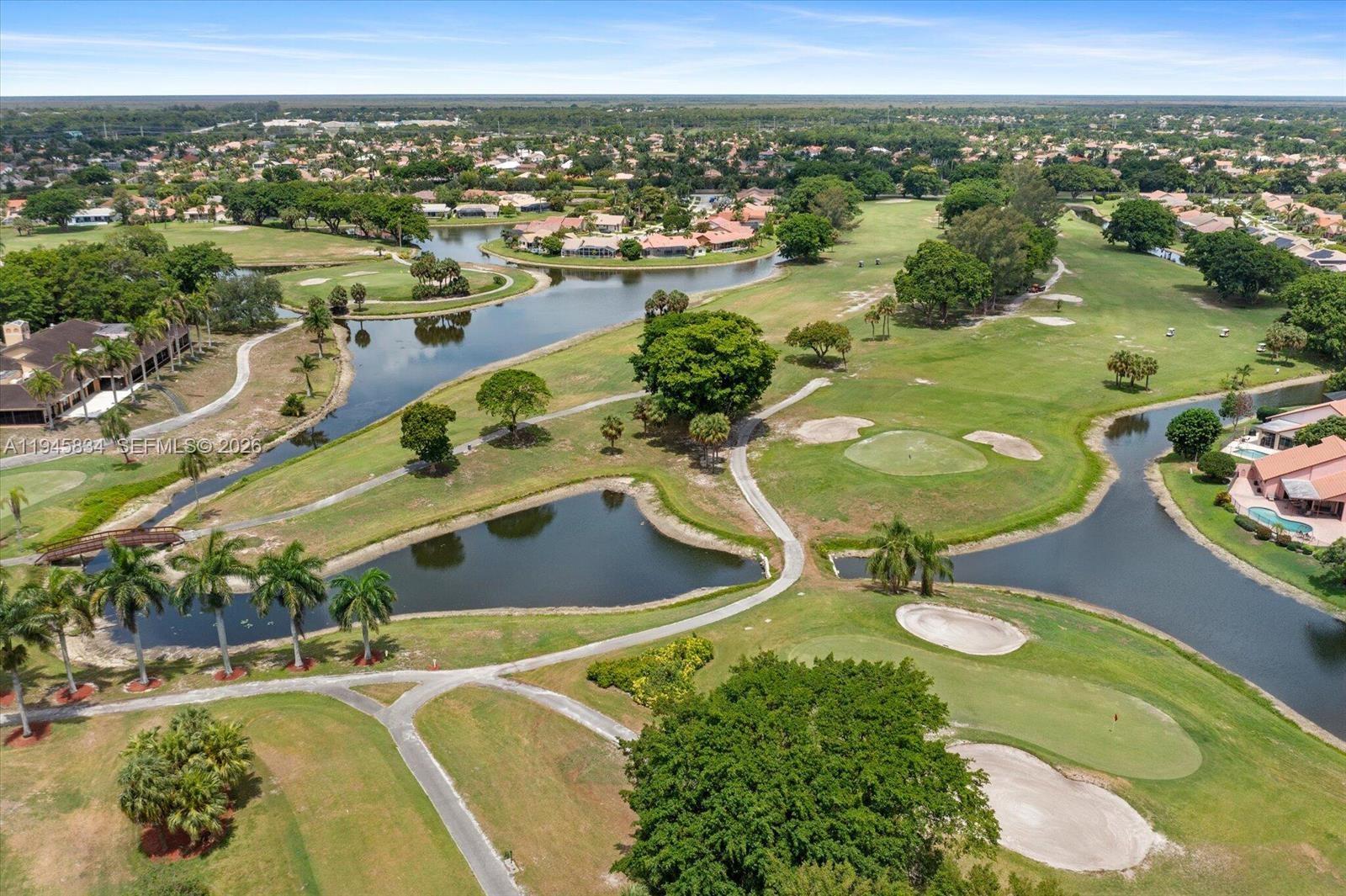 19648 Back 9 Drive Boca Raton, FL 33498 - Photo 34 of 45 a view of a swimming pool with a lot of trees & houses