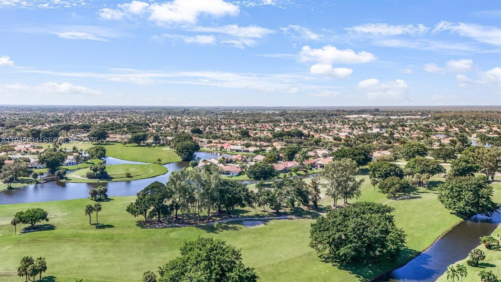 19648 Back 9 Drive Boca Raton, FL 33498 - Photo 35 of 45 an aerial view of a city with lots of residential buildings ocean and mountain view in back