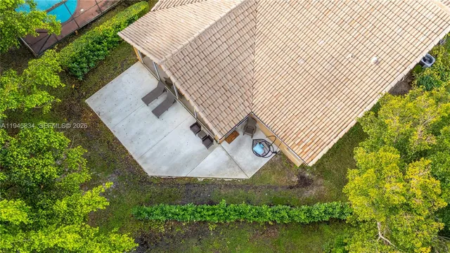 an aerial view of a house with a yard and lake view