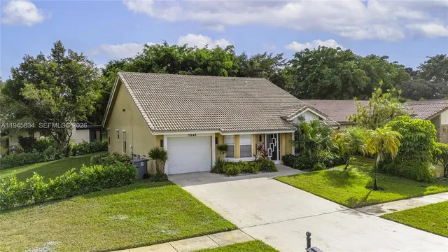 a aerial view of a house with yard and green space