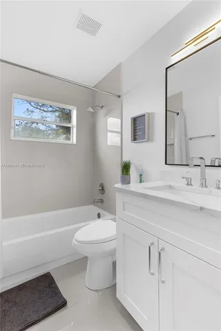 a bathroom with a sink a toilet and bathtub