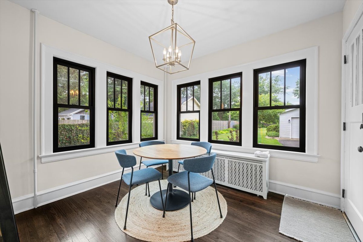 198 Wildwood Road Lake Forest, IL 60045 - Photo 15 of 37 a view of a dining room with furniture large windows and wooden floor