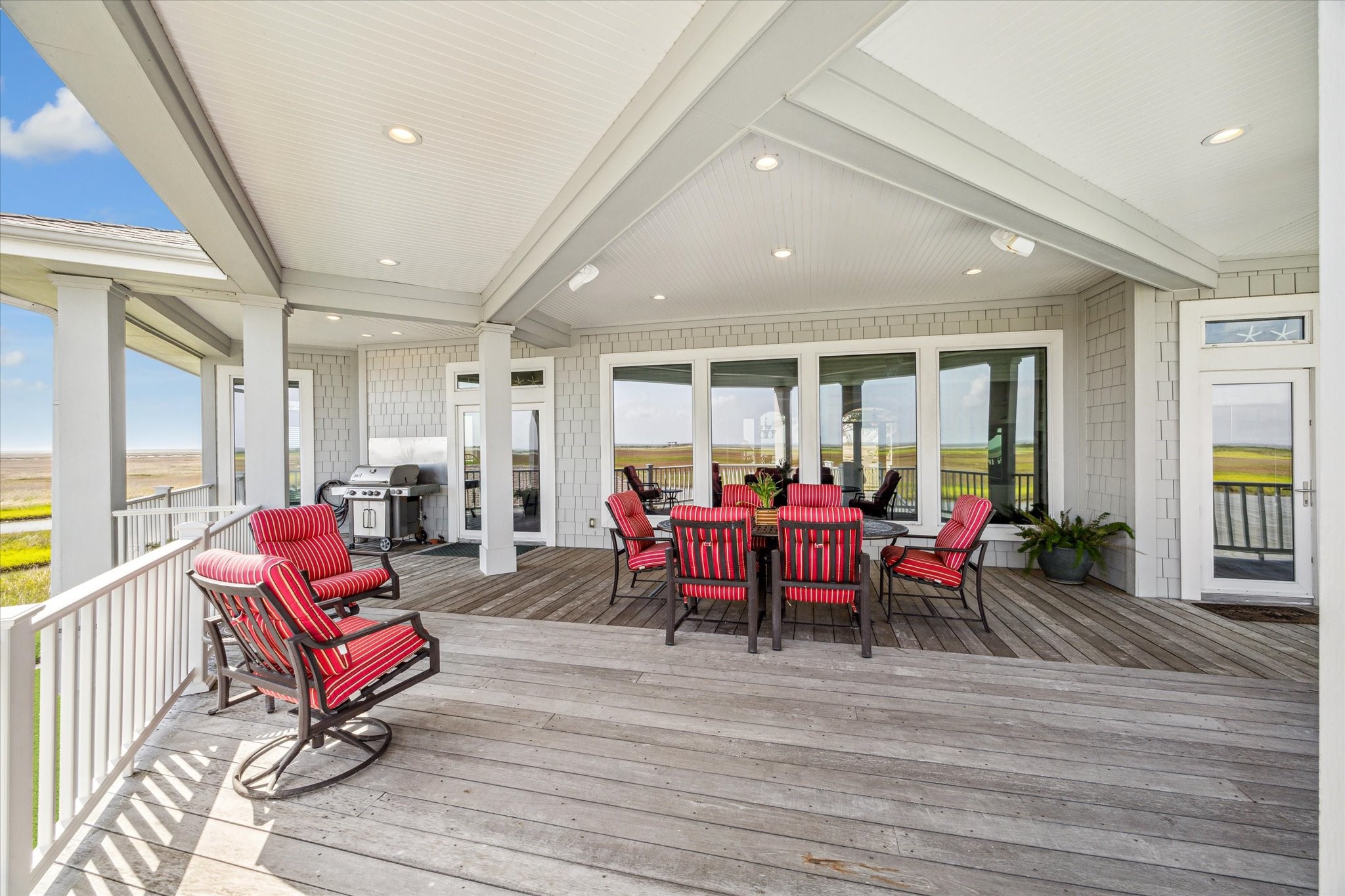 1 Shell Key Hitchcock, TX 77563 - Photo 41 of 50 Just off the main living area, step into an expansive covered patio deck designed for true coastal living. This generous outdoor space easily accommodates all your favorite furnishings—perfect for lounging, dining, and entertaining in comfort