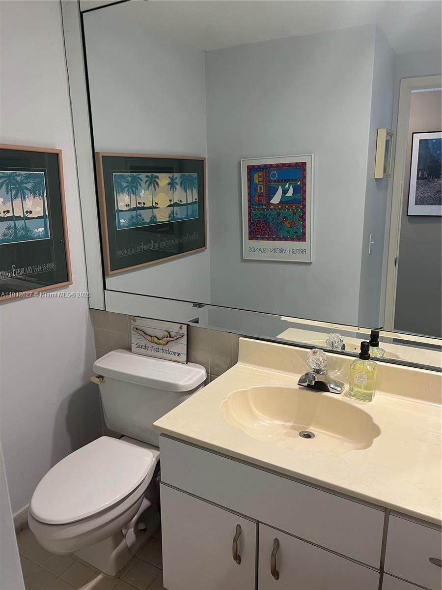 3800 Galt Ocean Drive, Unit 1403 Fort Lauderdale, FL 33308 - Photo 12 of 13 a bathroom with a toilet a sink and mirror