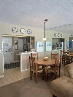 a dining room with furniture and window