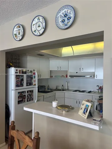 a kitchen with stainless steel appliances a stove and cabinets