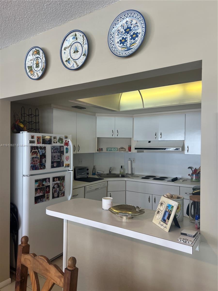 3800 Galt Ocean Drive, Unit 1403 Fort Lauderdale, FL 33308 - Photo 5 of 13 a kitchen with stainless steel appliances a stove and cabinets