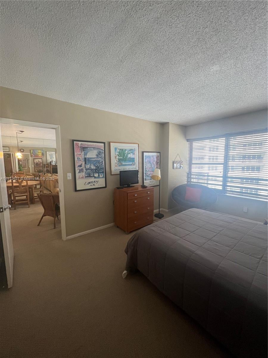 3800 Galt Ocean Drive, Unit 1403 Fort Lauderdale, FL 33308 - Photo 10 of 13 a bedroom with two beds and a window