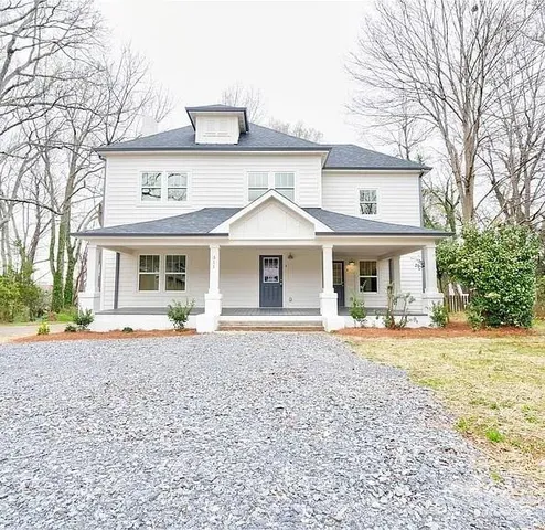 a front view of a house with a garden and patio