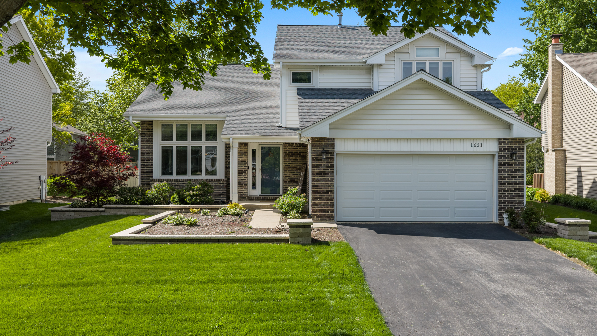 1631 Terri Circle Naperville, IL 60563 - Photo 1 of 39 a front view of a house with a yard and garage