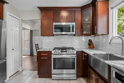 a kitchen with stainless steel appliances a stove a sink and a microwave