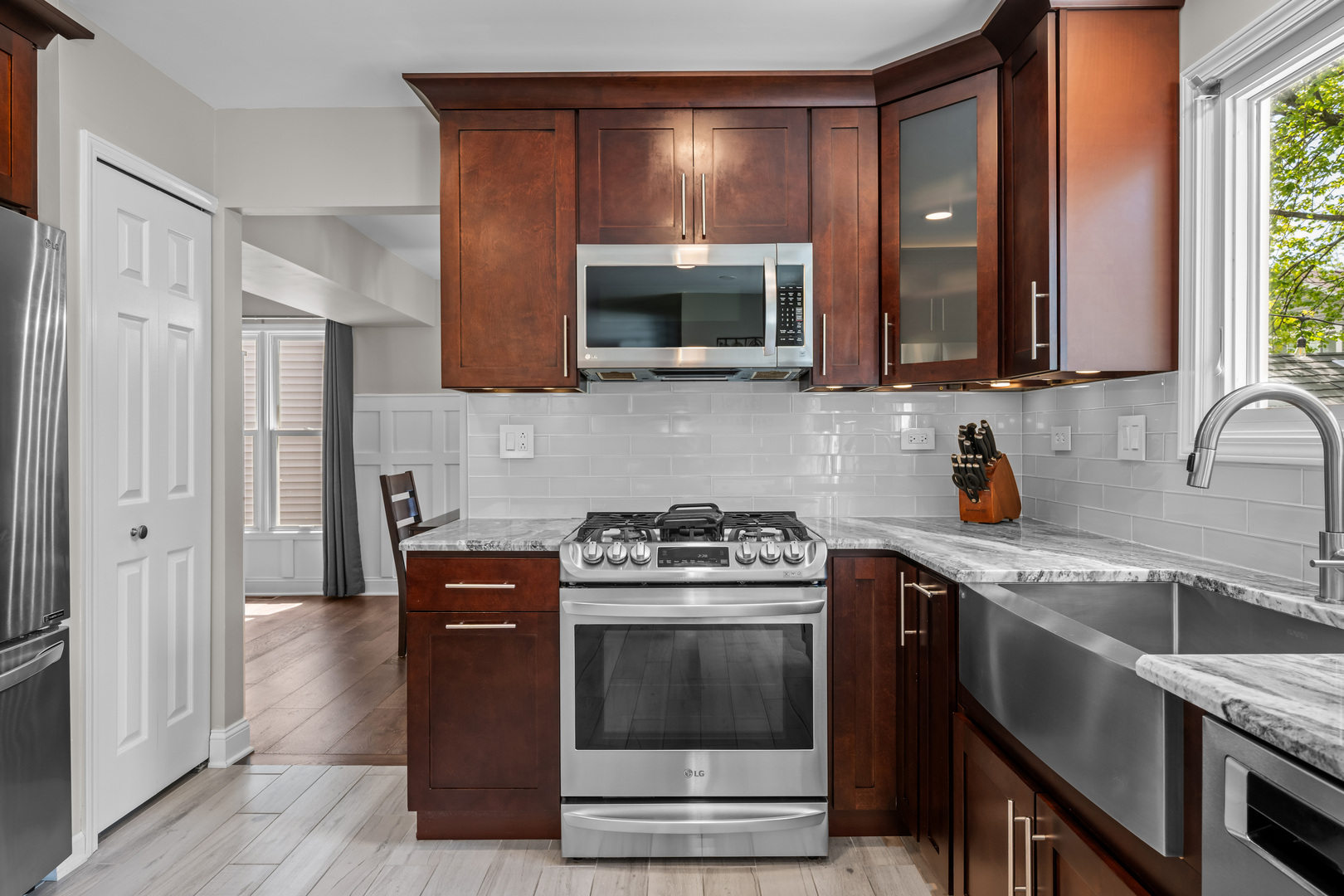 1631 Terri Circle Naperville, IL 60563 - Photo 11 of 39 a kitchen with stainless steel appliances a stove a sink and a microwave