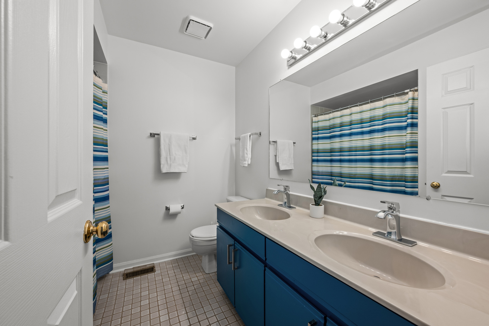 1631 Terri Circle Naperville, IL 60563 - Photo 20 of 39 a bathroom with a granite countertop double vanity sink a mirror and a toilet