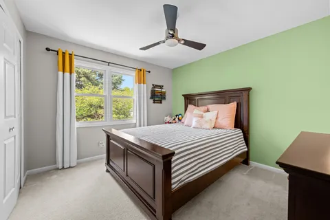 a bed sitting in a room next to a window