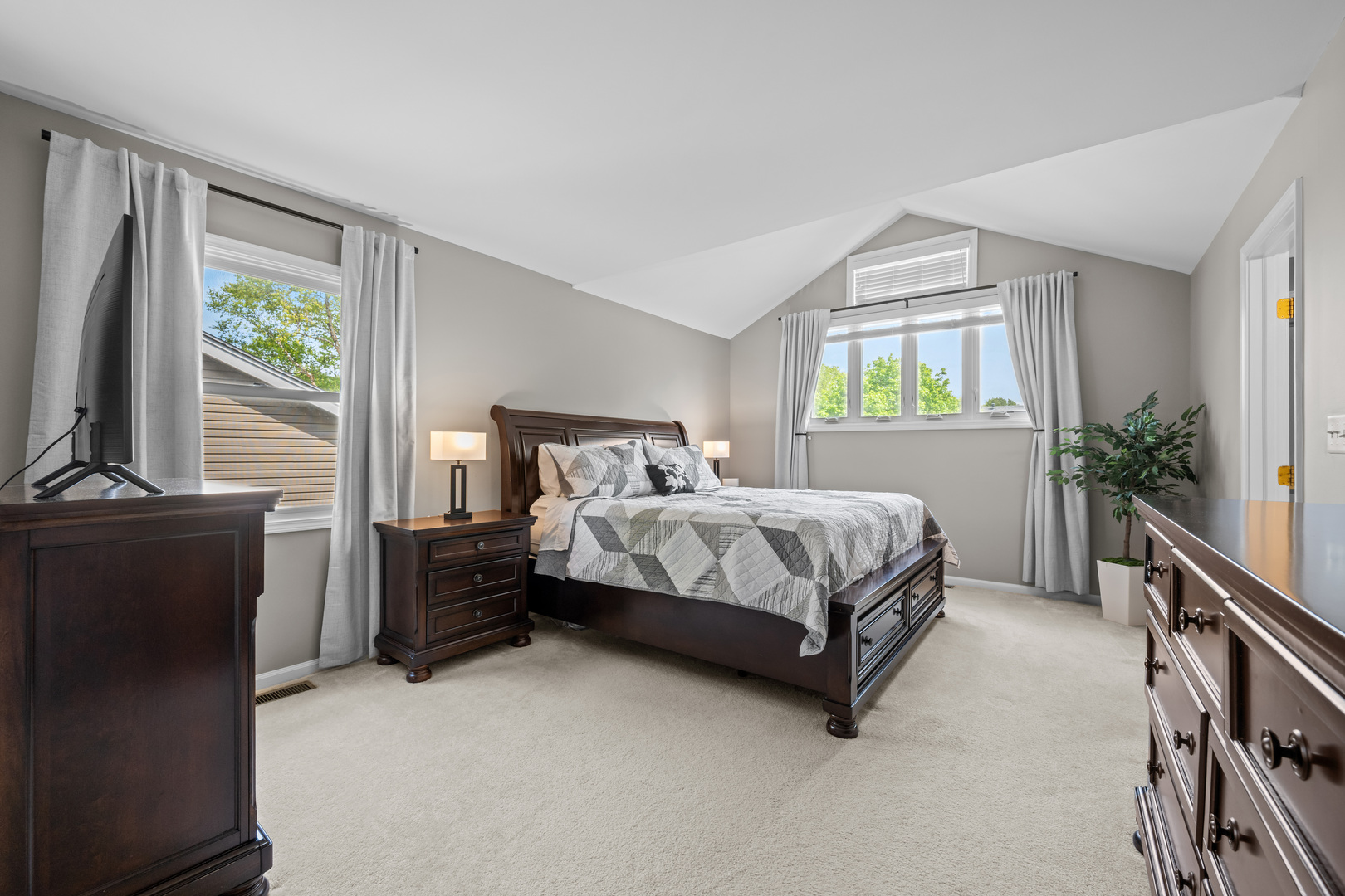 1631 Terri Circle Naperville, IL 60563 - Photo 22 of 39 a bedroom with a bed flat screen tv and a window