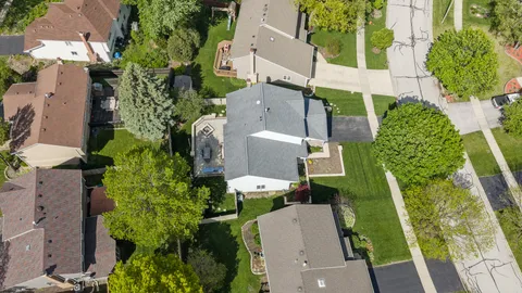 an aerial view of multiple houses with yard