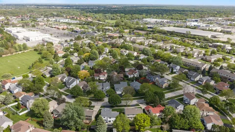 an aerial view of residential houses with outdoor space