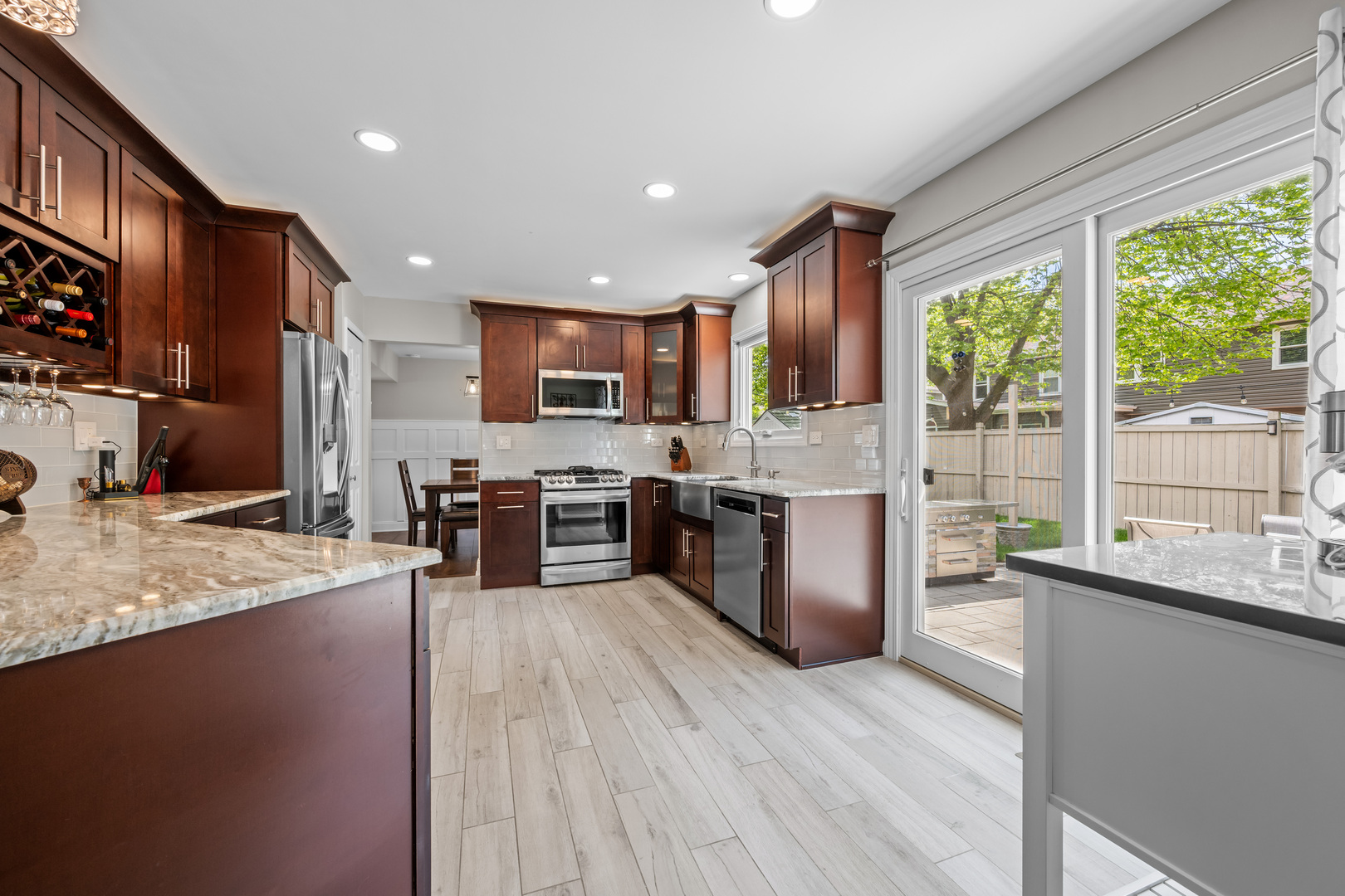 1631 Terri Circle Naperville, IL 60563 - Photo 9 of 39 a kitchen with stainless steel appliances granite countertop a stove a sink a refrigerator and a wooden cabinets
