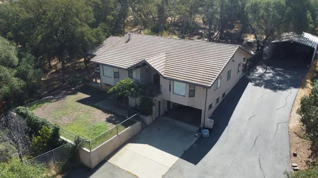 an aerial view of a house with porch and wooden floor