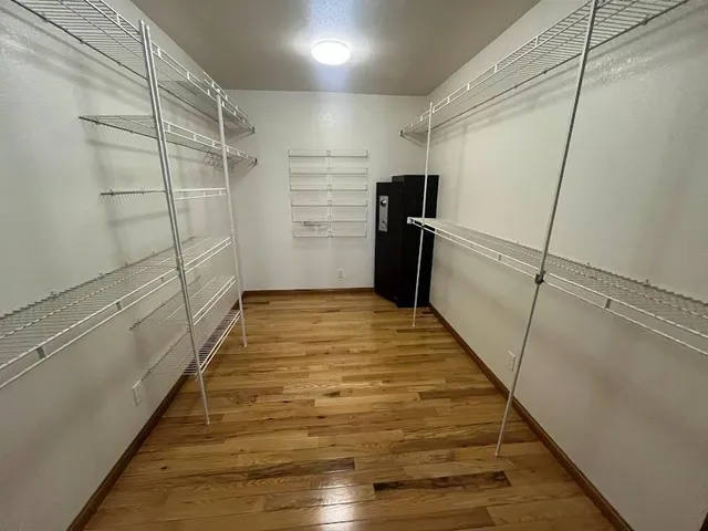 a view of a hardwood & staircase in a room