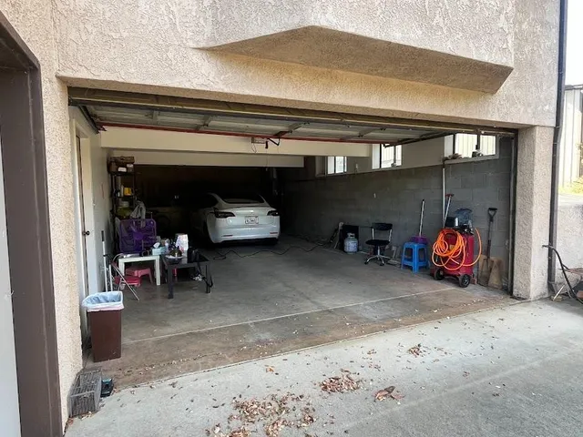 a view of a garage with rack and bicycle