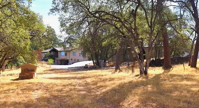 a view of a house with a yard covered in snow