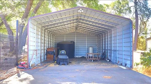 a view of a house with a small yard and wooden fence