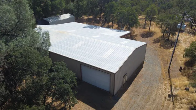 a view of a tall brick building with large trees