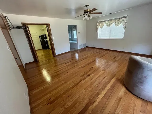 wooden floor in an empty room with a window