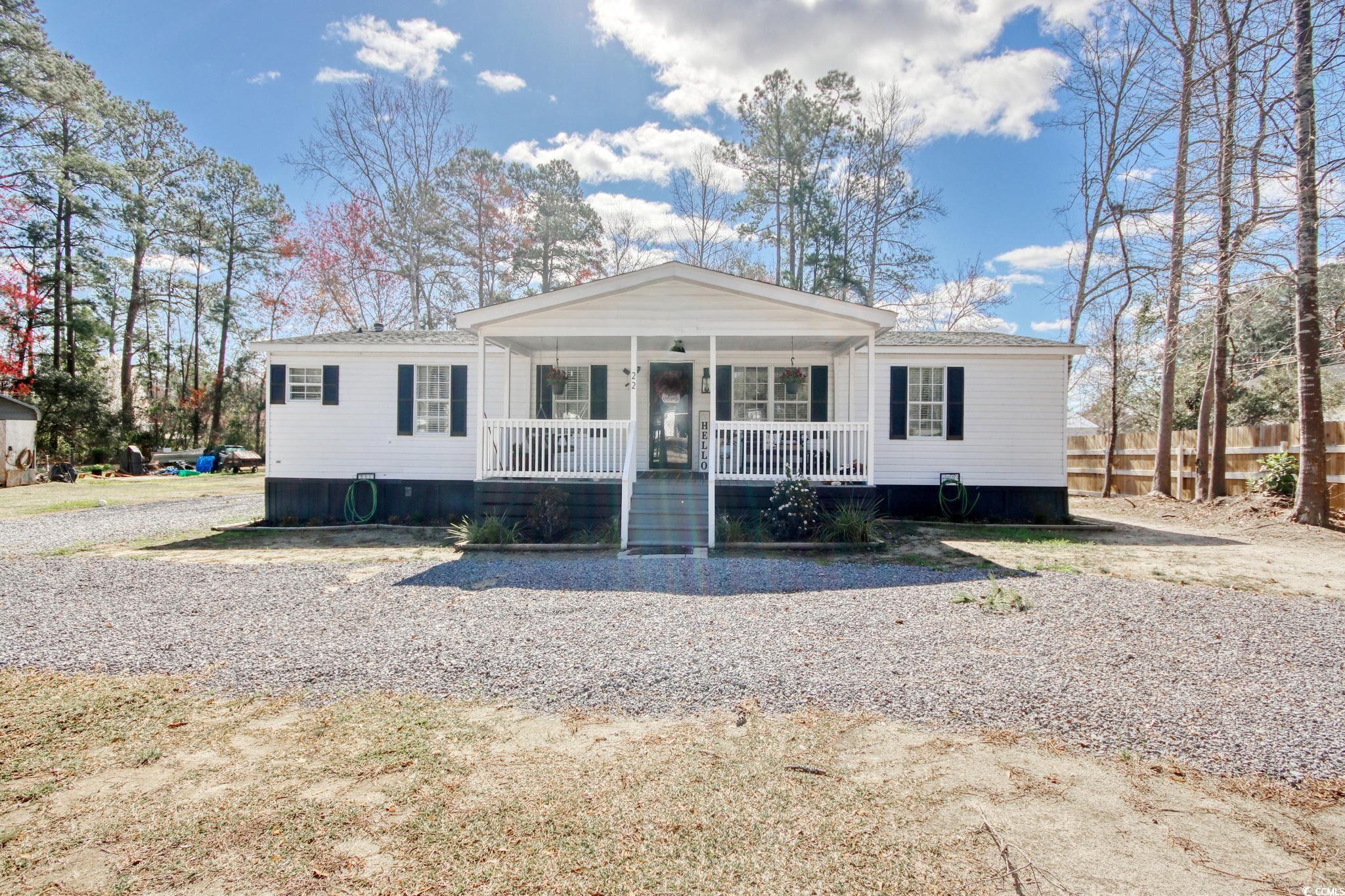 22 Beneventum Road Georgetown, SC 29440 - Photo 1 of 33 View of front of house with covered porch and fenc