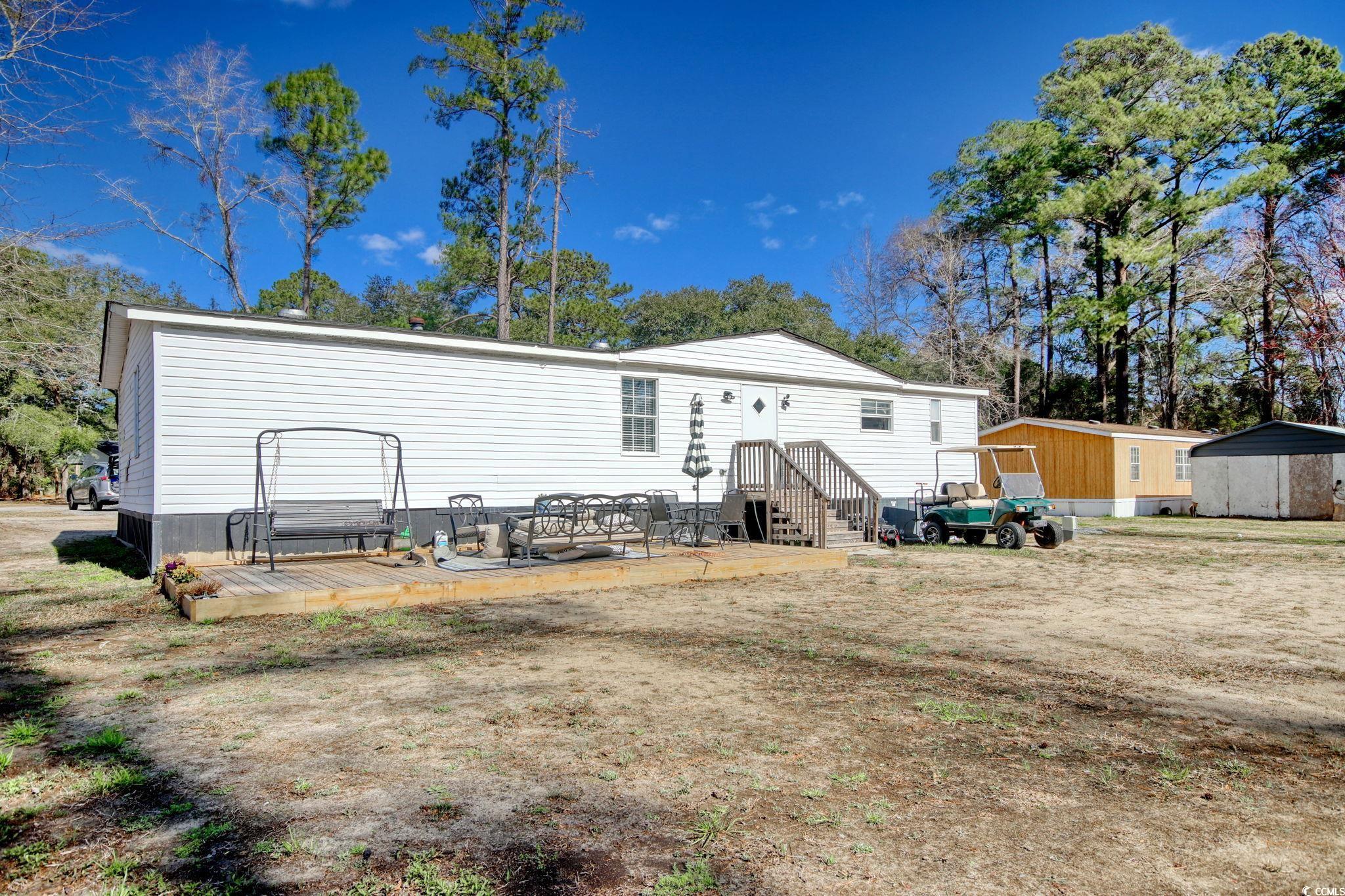 22 Beneventum Road Georgetown, SC 29440 - Photo 29 of 33 Back of house featuring an outdoor structure, a de