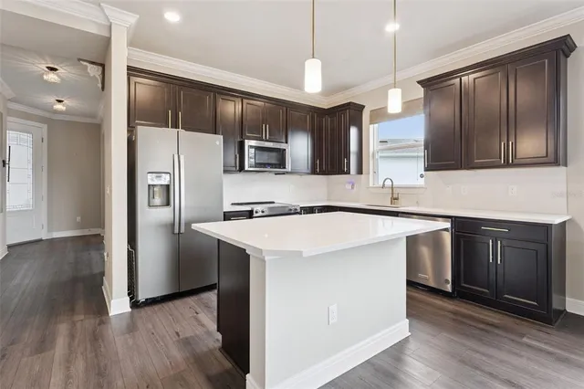 a kitchen with stainless steel appliances a sink stove and refrigerator