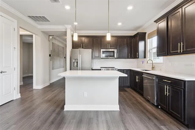 a kitchen with a sink stove and refrigerator